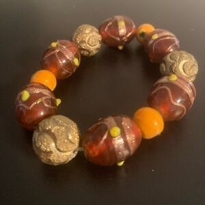 Orange and golden beaded bracelet.